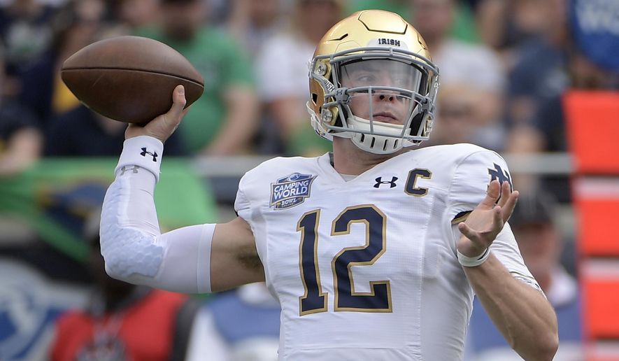 Notre Dame quarterback Ian Book (12) throws a pass during the first half of the Camping World Bowl NCAA college football game against Iowa State Saturday, Dec. 28, 2019, in Orlando, Fla. (AP Photo/Phelan M. Ebenhack)