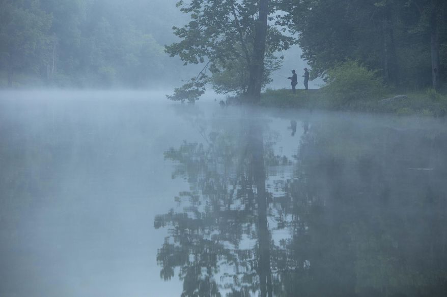This July 26, 2019 photo provided by The Nature Conservancy shows two people fishing in the mist and fog over the Clinch River as seen from the Clinch Riverwalk on Sugar Hill property in St. Paul, Va. The Cumberland Forest Project protects 253,000 acres of Appalachian forest in Tennessee, Kentucky, and Virginia and is one of TNC's largest-ever conservation efforts in the eastern United States. (Travis Dove/The Nature Conservancy via AP)