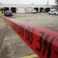 Police crime scene tape is shown in a parking lot after a deadly shooting Saturday, Dec. 28, 2019, in Houston. Multiple people were wounded when a group filming a music video was “ambushed” on Friday near Houston, Harris County Sheriff Ed Gonzalez said. (Melissa Phillip/Houston Chronicle via AP)