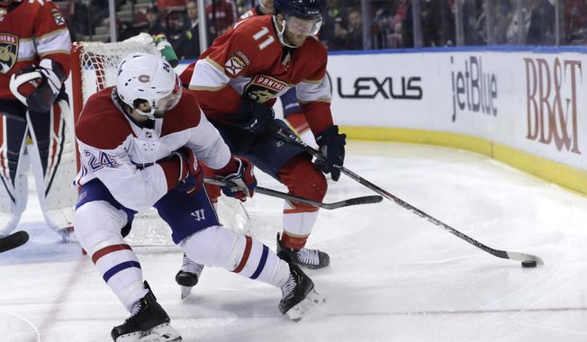 Florida Panthers left wing Jonathan Huberdeau (11) skates with the puck as Montreal Canadiens center Phillip Danault (24) defends during the second period of an NHL hockey game, Sunday, Dec. 29, 2019, in Sunrise, Fla. (AP Photo/Lynne Sladky)