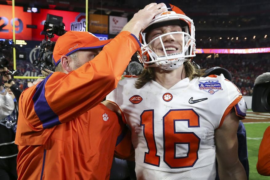 Clemson quarterback Trevor Lawrence (16) is congratulated after Clemson defeated Ohio State 29-23 in the Fiesta Bowl NCAA college football playoff semifinal Saturday, Dec. 28, 2019, in Glendale, Ariz. (AP Photo/Ross D. Franklin) **FILE**