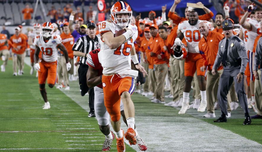 Clemson quarterback Trevor Lawrence runs for a touchdown against Ohio State during the first half of the Fiesta Bowl NCAA college football playoff semifinal Saturday, Dec. 28, 2019, in Glendale, Ariz. (AP Photo/Ross D. Franklin)