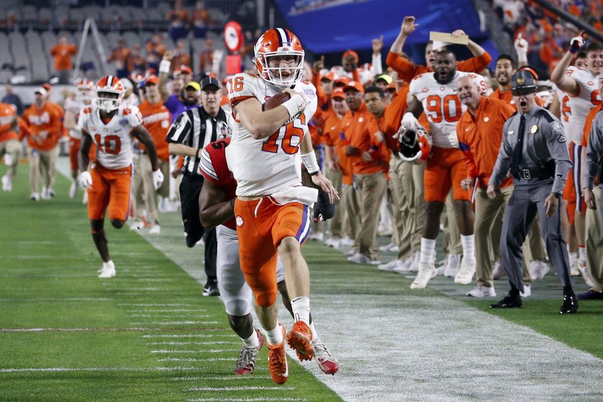 Clemson quarterback Trevor Lawrence runs for a touchdown against Ohio State during the first half of the Fiesta Bowl NCAA college football playoff semifinal Saturday, Dec. 28, 2019, in Glendale, Ariz. (AP Photo/Ross D. Franklin)