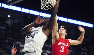 Penn State&#x27;s Mike Watkins (24) scores on Cornell&#x27;s Jimmy Boeheim (3) during first half action of an NCAA college basketball game, Sunday, Dec. 29, 2019, in State College, Pa. (AP Photo/Gary M. Baranec)