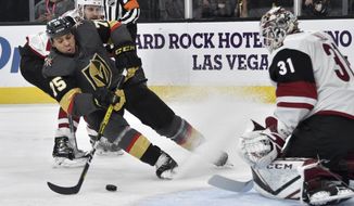 Vegas Golden Knights right wing Ryan Reaves (75) shoots against Arizona Coyotes goaltender Adin Hill during the second period of an NHL hockey game Saturday, Dec. 28, 2019, in Las Vegas. (AP Photo/David Becker)