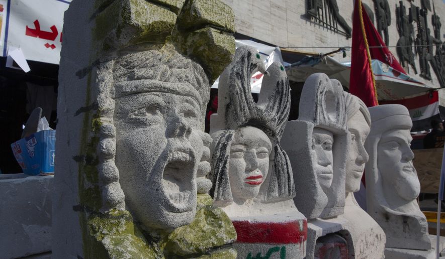 In this Tuesday, Dec. 17, 2019, photo, completed sculptures wait to be stored in preparation for an upcoming art exhibition, during the ongoing protests in Tahrir square, Baghdad, Iraq. Tahrir Square has emerged as a focus of the protests, with protesters camped out in dozens of tents. Dozens of people took part in the simple opening of the sculpture exhibition. (AP Photo/Nasser Nasser)