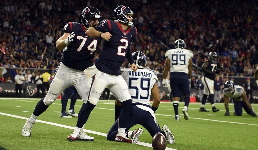 Houston Texans quarterback AJ McCarron (2) celebrates after scoring a touchdown as offensive guard Max Scharping (74) joins him while Tennessee Titans inside linebacker Wesley Woodyard (59) kneels at the goal line during the second half of an NFL football game Sunday, Dec. 29, 2019, in Houston. (AP Photo/Eric Christian Smith)