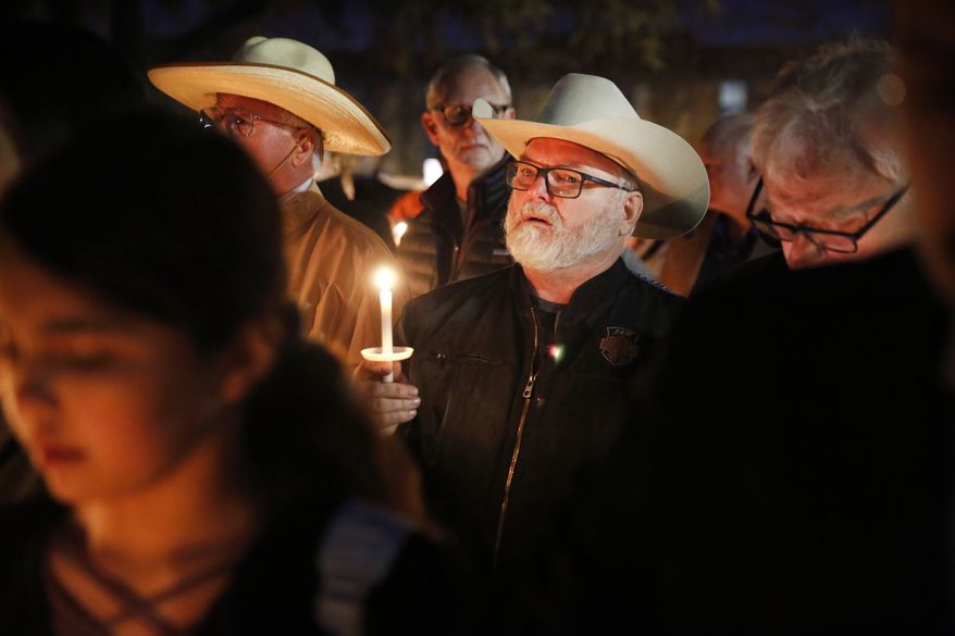 Stephen Willeford, who confronted and exchanged gunfire with the Sutherland Springs church shooter in 2017, joined church and community members outside West Freeway Church of Christ for a candlelight vigil Monday in White Settlement, Texas. A gunman shot and killed two people before an armed security officer returned fire, killing him during a service at the church on Sunday. (Associated Press/File)