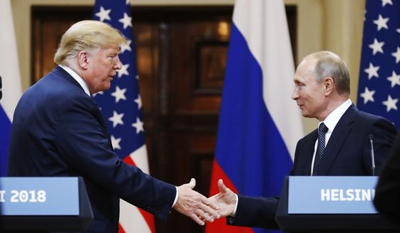 In this photo taken on Monday, July 16, 2018, U.S. President Donald Trump shakes hand with Russian President Vladimir Putin at the end of the press conference after their meeting at the Presidential Palace in Helsinki. (AP Photo/Alexander Zemlianichenko) **FILE**