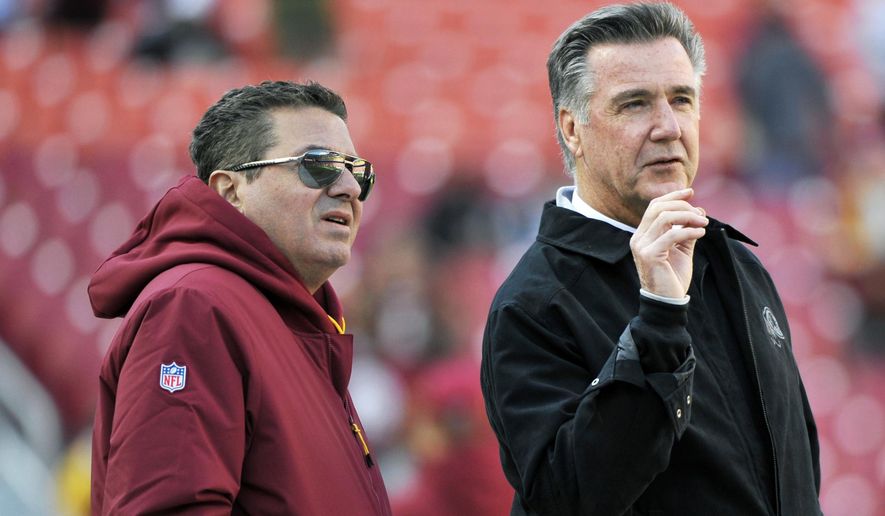 In this Oct. 21, 2018, photo, Washington Redskins owner Dan Snyder, left, and team president Bruce Allen talk on the field prior to an NFL football game between the Dallas Cowboys and Washington Redskins,  in Landover, Md. Allen was fired Monday, Dec. 30, 2019, after a tumultuous and loss-filled decade with the NFL team once coached by his father. (AP Photo/Mark Tenally) **FILE**