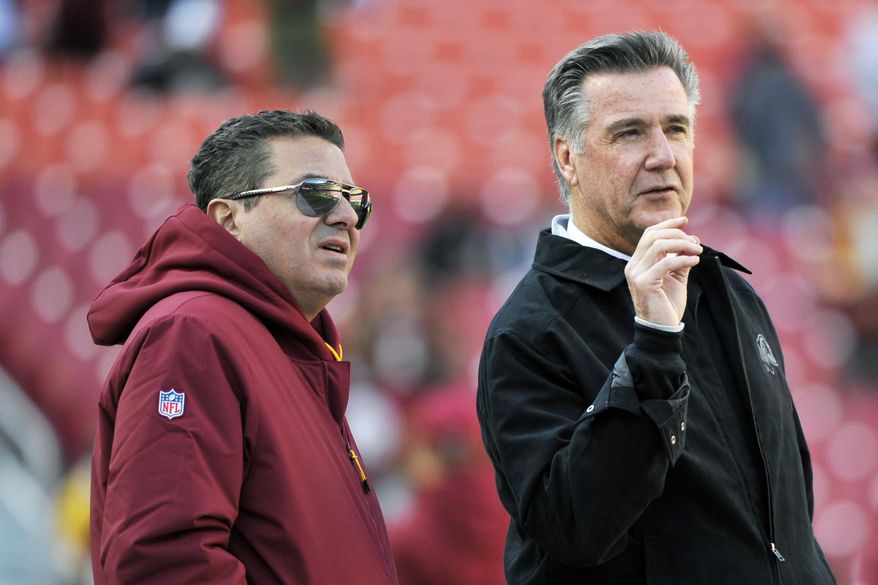 In this Oct. 21, 2018, photo, Washington Redskins owner Dan Snyder, left, and team president Bruce Allen talk on the field prior to an NFL football game between the Dallas Cowboys and Washington Redskins,  in Landover, Md. Allen was fired Monday, Dec. 30, 2019, after a tumultuous and loss-filled decade with the NFL team once coached by his father. (AP Photo/Mark Tenally) **FILE**