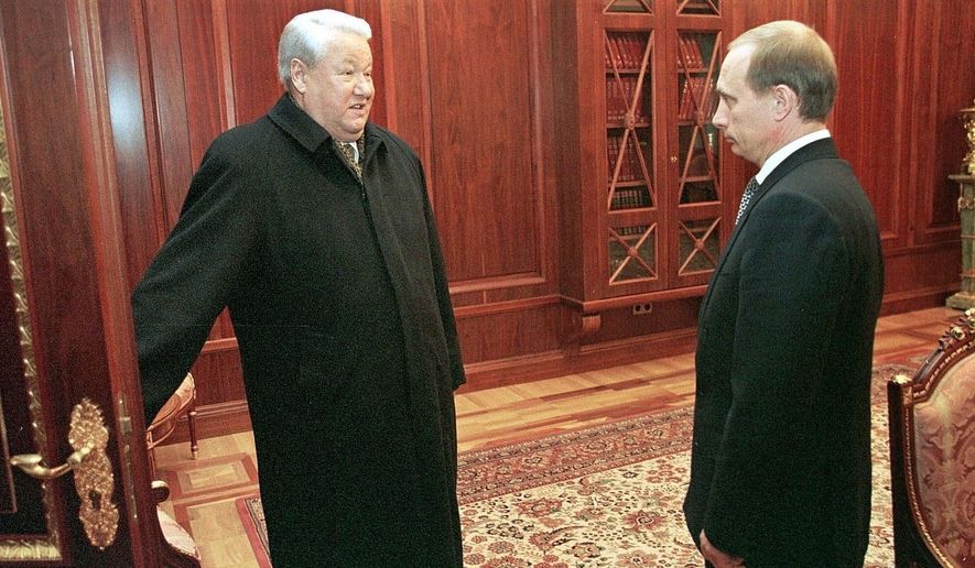 FILE In this file photo taken on Friday, Dec. 31, 1999, Former President Boris Yeltsin smiles as he talks to the then Russian acting President and Premier Vladimir Putin, in the Kremlin, Russia. Russian President Vladimir Putin prepares to mark his 20th year in power, as the longest-serving leader since Joseph Stalin.  (Sputnik, Kremlin Pool Photo via AP, File)
