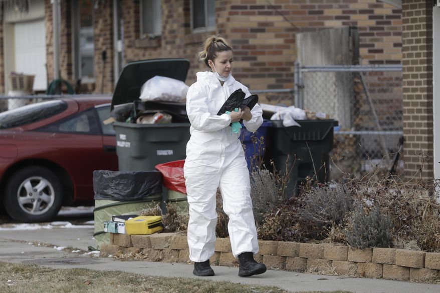 A member of the crime lab walks in front of a home Tuesday, Dec. 31, 2019, in West Valley City, Utah. A Utah mother is suspected of killing her 4-year-old daughter, The woman knocked on her neighbor's door in a Salt Lake City suburb early Tuesday morning and told them she had killed her daughter, West Valley City police said in a news release. Officers went to the house and found the woman waiting on the porch and the dead child in the basement of her home. (AP Photo/Rick Bowmer)