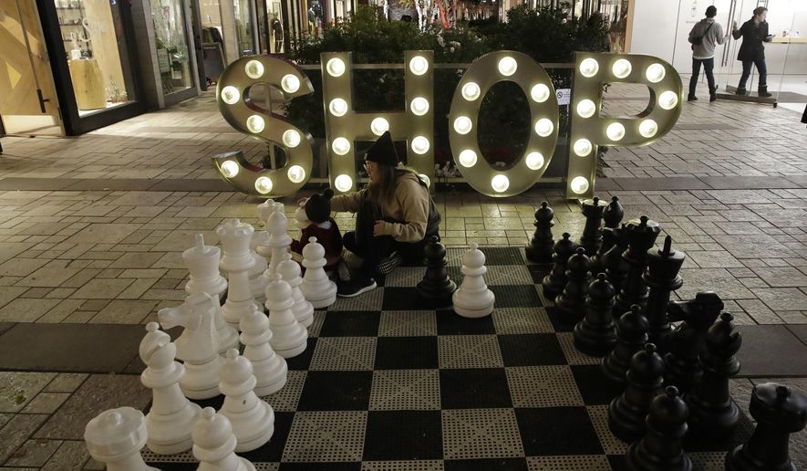 FILE - In this Dec. 16, 2019, file photo a shopping district is decorated for the holidays in Santa Clarita, Calif. On Tuesday, Dec. 31, the Conference Board reports on U.S. consumer confidence for December. (AP Photo/Marcio Jose Sanchez, File)