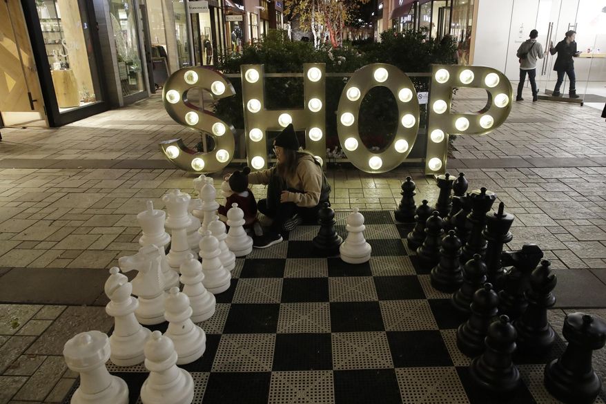 FILE - In this Dec. 16, 2019, file photo a shopping district is decorated for the holidays in Santa Clarita, Calif. On Tuesday, Dec. 31, the Conference Board reports on U.S. consumer confidence for December. (AP Photo/Marcio Jose Sanchez, File)