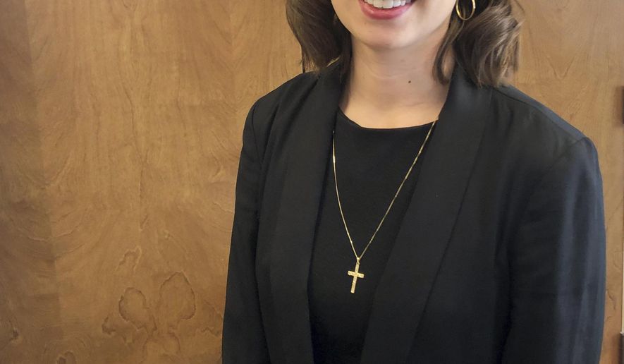 In this Nov. 21, 2019 photo, Rachel Sutphin, the daughter of William Morva who was executed in 2017 for the murder of Cpl. Eric Sutphin, poses after a hearing at the Capitol in Richmond, Va. A bill to abolish the death penalty has been filed by Del. Lee Carter, a Democrat from Manassas, and several additional bills are expected. (Frank Green/Richmond Times-Dispatch via AP)