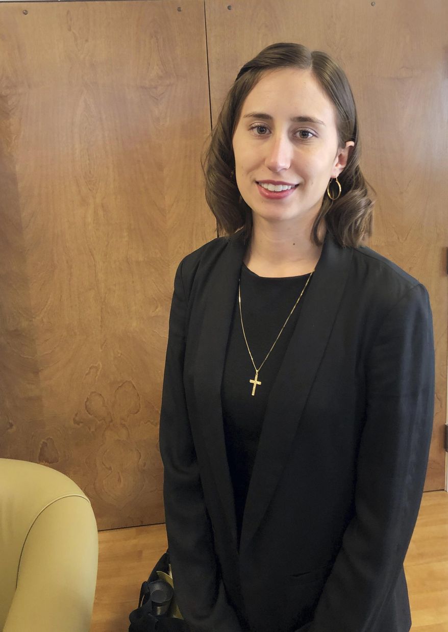 In this Nov. 21, 2019 photo, Rachel Sutphin, the daughter of William Morva who was executed in 2017 for the murder of Cpl. Eric Sutphin, poses after a hearing at the Capitol in Richmond, Va. A bill to abolish the death penalty has been filed by Del. Lee Carter, a Democrat from Manassas, and several additional bills are expected. (Frank Green/Richmond Times-Dispatch via AP)