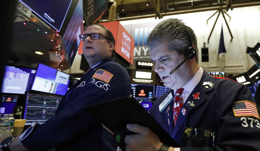In this Dec. 13, 2019, file photo specialist Gregg Maloney, left, and trader John Panin work on the floor of the New York Stock Exchange. The U.S. stock market opens at 9:30 a.m. EST on Tuesday, Dec. 31. (AP Photo/Richard Drew, File) **FILE**