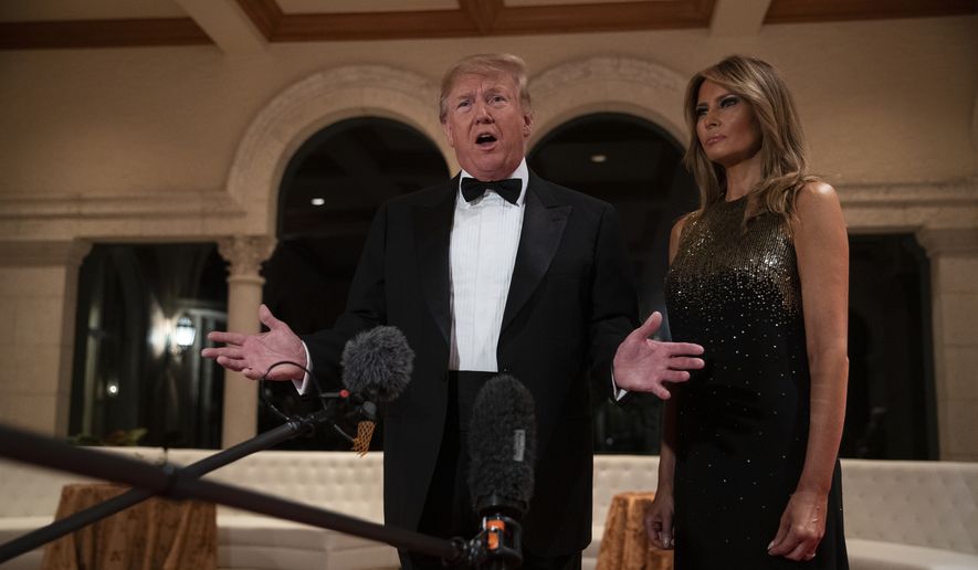President Donald Trump speaks to reporters before his New Year&#39;s Eve party at his Mar-a-Lago property, as first lady Melania Trump listens, Tuesday, Dec. 31, 2019, in Palm Beach, Fla. (AP Photo/ Evan Vucci)