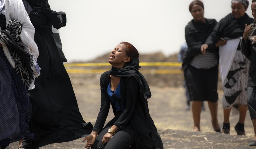 FILE - In this March 14, 2019 file photo, relatives of crash victims mourn at the scene where an Ethiopian Airlines Boeing 737 Max 8 passenger jet crashed shortly after takeoff, killing all 157 on board, near Bishoftu, in Ethiopia. These African stories captured the world's attention in 2019 - and look to influence events on the continent in 2020. (AP Photo/Mulugeta Ayene, File)