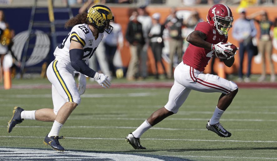 Alabama wide receiver Jerry Jeudy (4) runs after a reception past Michigan linebacker Jordan Glasgow (29) during the first half of the Citrus Bowl NCAA college football game, Wednesday, Jan. 1, 2020, in Orlando, Fla. (AP Photo/John Raoux)