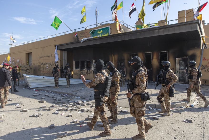 Iraqi army soldiers are deployed in front of the U.S. Embassy, in Baghdad, Iraq, Wednesday, Jan. 1, 2020. Iran-backed militiamen have withdrawn from the U.S. Embassy compound in Baghdad after two days of clashes with American security forces. (AP Photo/Nasser Nasser) ** FILE **