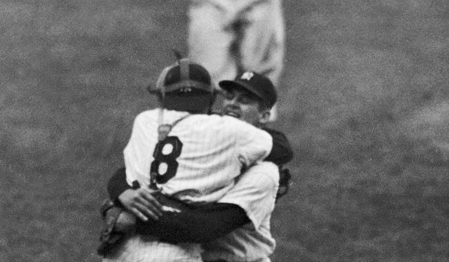 In this Oct. 8, 1956, file photo, New York Yankees catcher Yogi Berra leaps into the arms of pitcher Don Larsen after Larsen struck out the last Brooklyn Dodgers batter to complete his perfect game during Game 5 of the World Series in New York. Larsen, the journeyman pitcher who reached the heights of baseball glory in 1956 for the Yankees when he threw a perfect game and only no-hitter in World Series history, died Wednesday, Jan. 1, 2020. He was 90. (AP Photo/File)