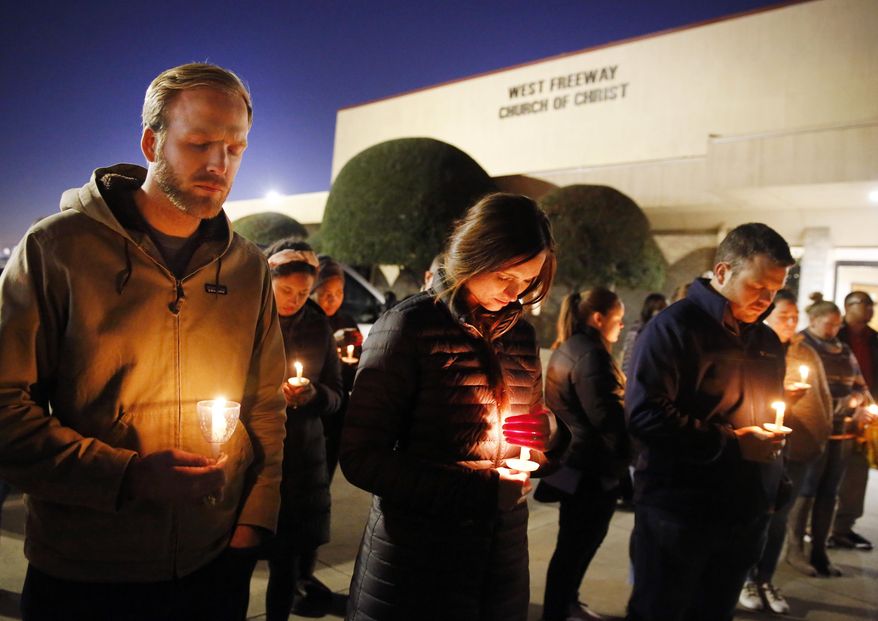 In this Monday, Dec. 30, 2019, file photo, church and community members, including Matt Pacholczyk, left, and his wife, Faith Pacholczyk, stand outside West Freeway Church of Christ for a candlelight vigil in White Settlement, Texas. The machete attack on a rabbi's home in Monsey, New York, during Hanukkah and the shooting of worshippers at a Texas church are refocusing attention on how vulnerable worshippers are during religious services. FBI hate crime statistics show there is reason for concern. (Tom Fox/The Dallas Morning News via AP, File)