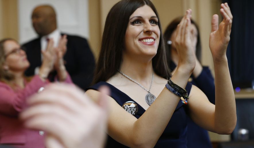 FILE - In this Jan. 9, 2019 file photo, Del. Danica Roem, D-Prince William, right, applauds visitors during opening ceremonies at the start of the 2019 session of the Virginia General Assembly in the House chambers at the Capitol in Richmond, Va. Supporters of the Equal Rights Amendment are confident Virginia is on the verge of becoming the critical 38th state to ratify the gender equality measure. The proposed 28th amendment to the U.S. Constitution faces a host of likely legal challenges and vehement opposition from conservative activists who depict the ERA as a threat to their stances on abortion and transgender rights.(AP Photo/Steve Helber)
