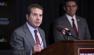 In this file photo, Washington Redskins owner Dan Snyder, left, speaks, accompanied by head coach Ron Rivera, during a news conference at the team&#x27;s NFL football training facility, Thursday, Jan. 2, 2020 in Ashburn, Va. Mr. Snyder has tapped D.C. attorney Beth Wilkinson to lead up an internal investigation into allegations of sexual harassment and a toxic work culture within the NFL franchise. (AP Photo/Alex Brandon) ** FILE **