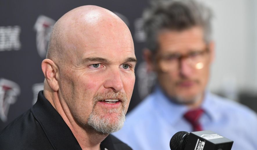 Atlanta Falcons coach Dan Quinn, left, and general manager Thomas Dimitroff face the media during a news conference held by the NFL football team, Monday, Dec. 30, 2019, in Flowery Branch, Ga. Quinn and Dimitroff were in the hot seat earlier this season after a poor start, but owner Arthur Blank made the decision to retain both of them last week. (John Amis/Atlanta Journal-Constitution via AP)