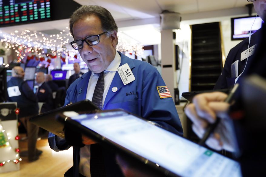 In this Dec. 11, 2019, file photo trader Sal Suarino works on the floor of the New York Stock Exchange. The U.S. stock market opens at 9:30 a.m. EST on Thursday, Jan. 2, 2020. (AP Photo/Richard Drew, File)