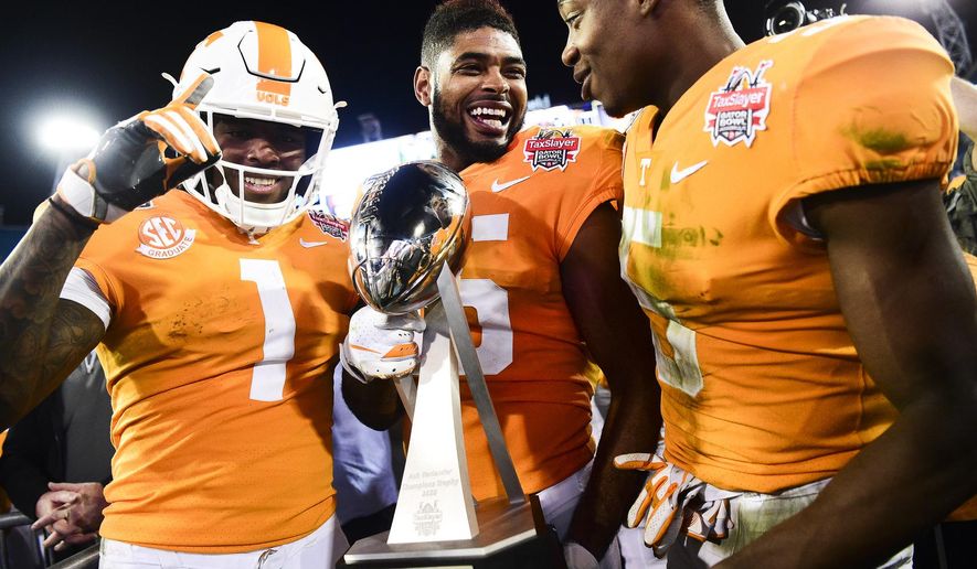 Tennessee wide receiver Jauan Jennings (15) holds the trophy next to wide receivers Marquez Callaway (1) and Josh Palmer (5) after the team's 23-22 win over Indiana in the Gator Bowl NCAA college football game in Jacksonville, Fla., Thursday, Jan. 2, 2020. (Calvin Mattheis/Knoxville News Sentinel via AP)
