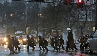 In this Monday, Dec. 30, 2019, photo, a group of orthodox Jewish children cross the street in Monsey, N.Y. With the rapid expansion of Orthodox communities outside New York City has come civic sparring, and some fear the recent violence in the area may be an outgrowth of that conflict. (AP Photo/Seth Wenig)