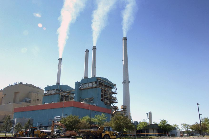 FILE - In this July 1, 2013, file photo, gas emissions rises from a coal-burning power plant in Colstrip, Mont. One of the largest coal-fired power plants in the western U.S. will close two of its four units by Saturday, Jan. 4, 2020, as the Montana facility edges toward an eventual total shutdown. (AP Photo/Matthew Brown, File)