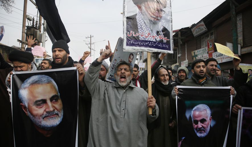 Kashmiri Shiite Muslims shout anti American and anti Israel slogans during a protest against U.S. airstrike in Iraq that killed Iranian Revolutionary Guard Gen. Qassem Soleimani, seen in the photographs, at Magam 37 kilometers (23 miles) north of Srinagar, Indian controlled Kashmir, Friday, Jan. 3, 2020. The killing of Iran&#x27;s top military commander Gen. Qassem Soleimani triggered several anti-U.S. protests in Indian-controlled Kashmir, the protesters also shut down shops and businesses in Magam and Budgam towns in south Kashmir. (AP Photo/Mukhtar Khan)