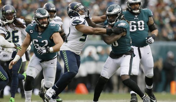 FILE - In this Nov. 24, 2019, file photo, Philadelphia Eagles&#39; Jay Ajayi (28) tries to break free from Seattle Seahawks&#39; Bobby Wagner during the second half of an NFL football game in Philadelphia. Wagner was named to The Associated Press&#39; All-Pro Team for the fifth time. (AP Photo/Michael Perez, File)