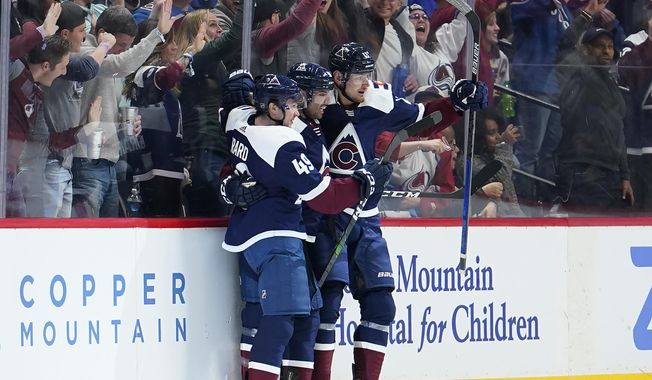 Colorado Avalanche center Pierre-Edouard Bellemare, center, celebrates a goal against the St. Louis Blues with teammates Samuel Girard (49) and Valeri Nichushkin during the second period of an NHL hockey game, Thursday, Jan. 2, 2020, in Denver (AP Photo/Jack Dempsey)
