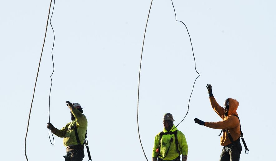 FILE - In this Dec. 3, 2019, file photo workers erect a building under construction, in Philadelphia. On Friday, Jan. 3, 2020, the Commerce Department reports on U.S. construction spending in November. (AP Photo/Matt Rourke, File)