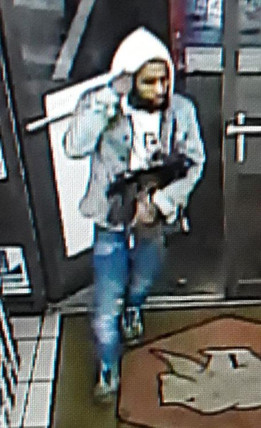 This image provided by the Lafourche Parish Sheriff Office shows a suspect entering a convenience store in Galliano, La. Louisiana authorities are trying to identify a man who left apparent designer bags holding drugs, a gun, cash and a digital scale in a convenience store. The man went into the store early Thursday, Jan. 2, 2020 and put the apparent Louis Vuitton and Gucci bags on a chair, according to a news release. (Lafourche Parish Sheriff Office via AP)