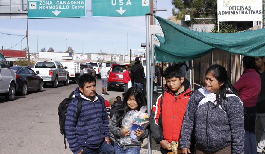 The Gonzalez family of five from Guatemala, who are applying for asylum in the U.S., stand for a family portrait before going to a soup kitchen to eat in Nogales, Mexico, on the U.S. border, Friday, Jan. 3, 2020. The family was sent by U.S. authorities to Nogales, Mexico on Thursday as part of the so-called “Remain in Mexico” program, and have a court appointment in El Paso on March 23. Lorenzo Gonzalez said the five of them were separated while being processed in the U.S. immigration system, after they turned themselves in to authorities in the sister city Nogales, Arizona. (AP Photo/Luis Enrique Castillo)