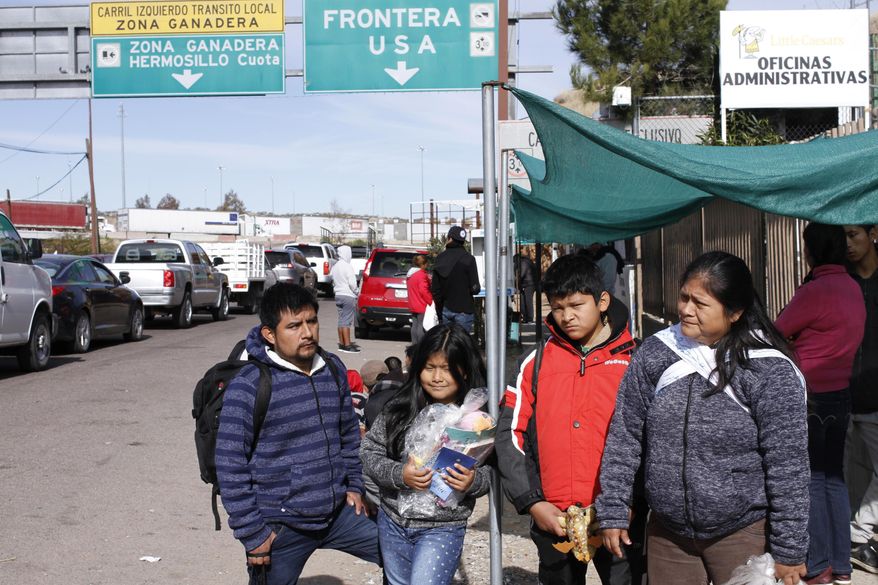 The Gonzalez family of five from Guatemala, who are applying for asylum in the U.S., stand for a family portrait before going to a soup kitchen to eat in Nogales, Mexico, on the U.S. border, Friday, Jan. 3, 2020. The family was sent by U.S. authorities to Nogales, Mexico on Thursday as part of the so-called “Remain in Mexico” program, and have a court appointment in El Paso on March 23. Lorenzo Gonzalez said the five of them were separated while being processed in the U.S. immigration system, after they turned themselves in to authorities in the sister city Nogales, Arizona. (AP Photo/Luis Enrique Castillo)