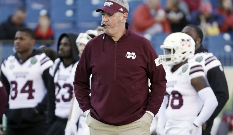 FILE - In this Dec. 30, 2019, file photo, Mississippi State head coach Joe Moorhead watches as players warm up before the Music City Bowl NCAA college football game against Louisville, in Nashville, Tenn. Two people with knowledge of the situation say Mississippi State has fired coach Joe Moorhead after just two seasons. They spoke to The Associated Press on condition of anonymity because an announcement had not yet been made by the school. A meeting was scheduled Friday, Jan. 3, 2020, with Moorhead and athletic director John Cohen.(AP Photo/Mark Humphrey, File)