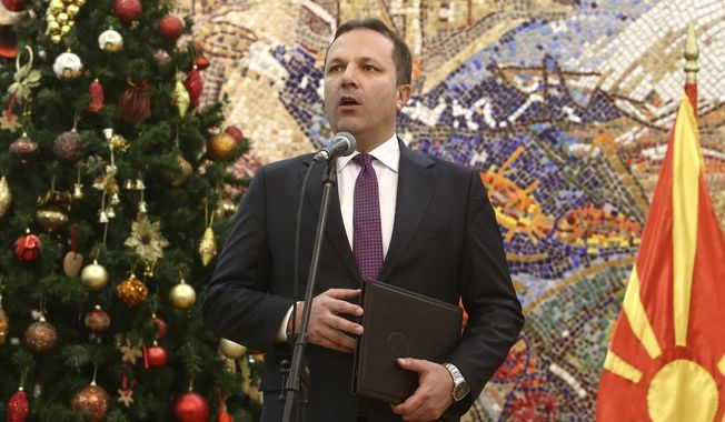 Oliver Spasovski, nominated to serve as prime minister of the caretaker government, talks for the media after receiving the mandate from the president Stevo Pendarovski, at the presidential office in Skopje, North Macedonia, Friday, Jan. 3, 2020.  The prime minister of North Macedonia Zoran Zaev submitted his resignation Friday, paving the way for a new caretaker Cabinet to be named in order to organize a snap election. (AP Photo/Boris Grdanoski)