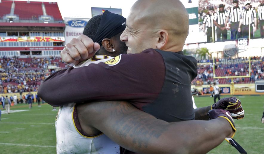 Minnesota head coach P.J. Fleck, right, hugs wide receiver Tyler Johnson after Minnesota defeated Auburn during the Outback Bowl NCAA college football game Wednesday, Jan. 1, 2020, in Tampa, Fla. (AP Photo/Chris O'Meara)