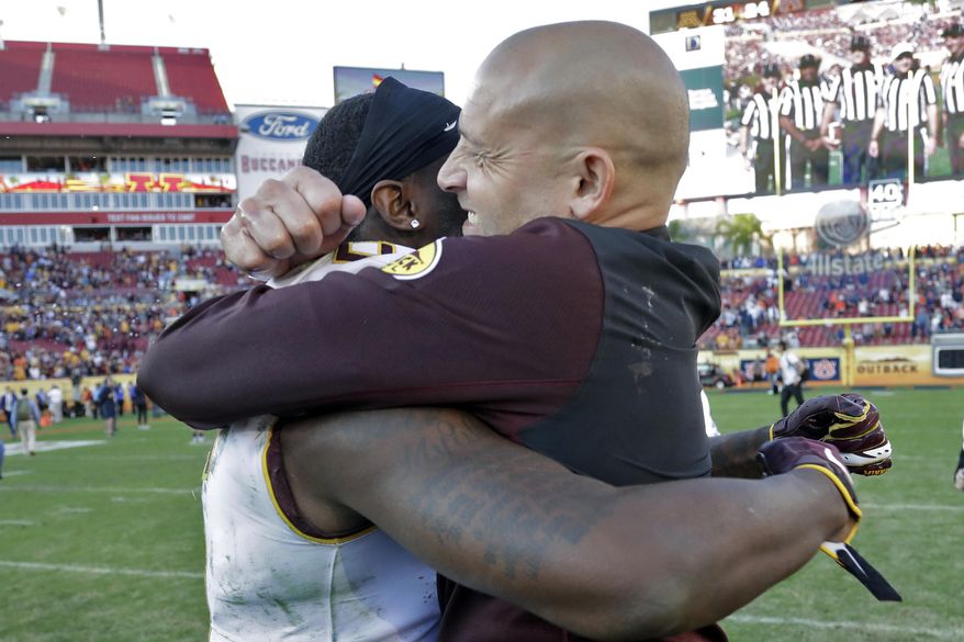 Minnesota head coach P.J. Fleck, right, hugs wide receiver Tyler Johnson after Minnesota defeated Auburn during the Outback Bowl NCAA college football game Wednesday, Jan. 1, 2020, in Tampa, Fla. (AP Photo/Chris O'Meara)