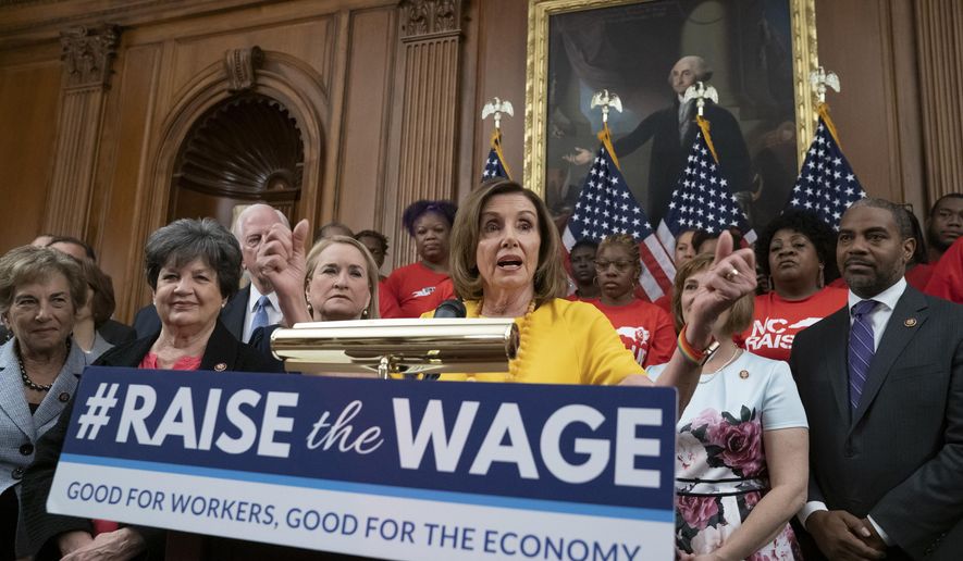 FILE - In this July 18, 2019, file photo speaker of the House Nancy Pelosi, D-Calif., joins fellow Democrats and activists seeking better pay as the House approved legislation to raise the federal minimum wage for the first time in a decade _ to $15 an hour, at the Capitol in Washington. As of Jan. 1, 2020, there are higher minimum wages in a quarter of the states, and new federal overtime rules. (AP Photo/J. Scott Applewhite, File)