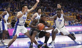 Wake Forest&#39;s Chaundee Brown. center, tries to control the ball as Pittsburgh&#39;s Eric Hamilton (0) and Trey McGowens (2) defend during the first half of an NCAA college basketball game, Saturday, Jan. 4, 2020, in Pittsburgh. (AP Photo/Keith Srakocic)