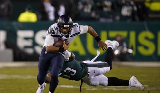Seattle Seahawks&#x27; Russell Wilson (3) rushes past Philadelphia Eagles&#x27; Nigel Bradham (53) during the second half of an NFL wild-card playoff football game, Sunday, Jan. 5, 2020, in Philadelphia. (AP Photo/Chris Szagola)