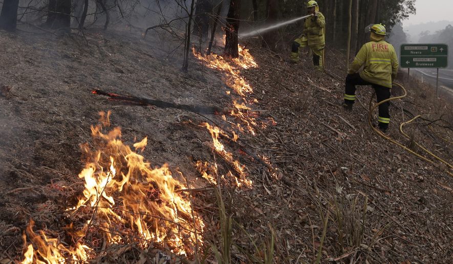 Firefighters manage a controlled burn to help contain a larger fire near Falls Creek, Australia, Sunday, Jan. 5, 2020. The deadly wildfires, which have been raging since September, have already burned about 5 million hectares (12.35 million acres) of land and destroyed more than 1,500 homes. (AP Photo/Rick Rycroft)